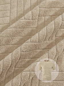 Close-up of khaki knit polo fabric featuring detailed geometric jacquard towel texture