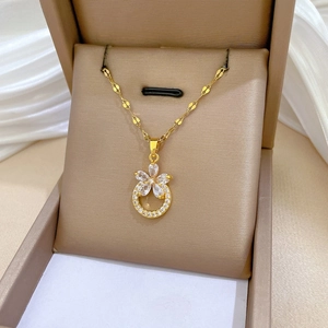 Detailed view of titanium steel floral pendant necklace with pavé zircons in a jewelry box