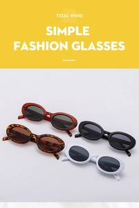 Detailed view of oval vintage sunglasses in red, black, white, and leopard patterns