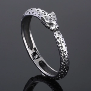 Macro shot of silver leopard head cuff bracelet with black etched spotted patterns