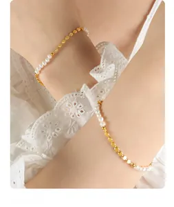 Detailed macro view of elegant freshwater pearl and polished gold bead link chain bracelet