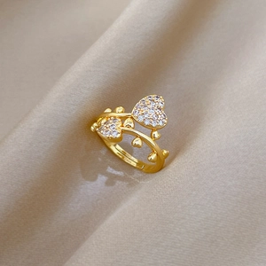 Adjustable gold plated ring with interlocking double hearts pavé set with white zircons