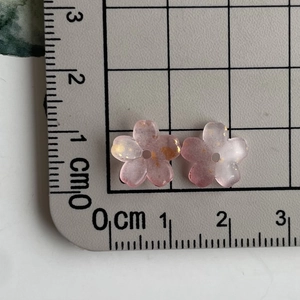 Detail view of pink resin flower charms with gold leaf and 1cm size measurement