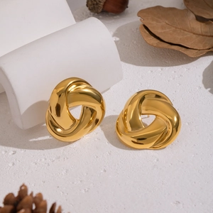 Minimalist gold geometric twist stud earrings on a minimalist white textured backdrop