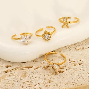 Set of four gold-plated adjustable rings featuring heart, crown, and starfish zircon motifs