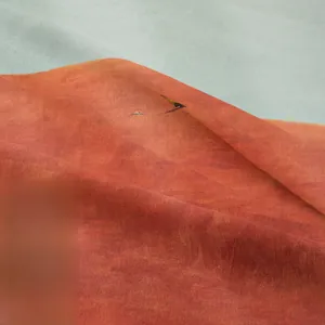Close-up of bohemian tapestry showing high-density orange and grey microfiber texture