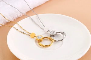 Detail view of gold and silver stainless steel round necklaces with small crystals