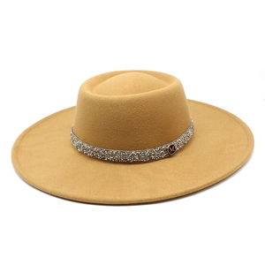 Macro shot of khaki wool felt hat featuring a sparkling rhinestone band and metal M logo