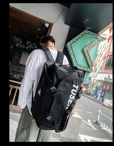Detail of black large capacity oxford backpack featuring TUSE logo on side