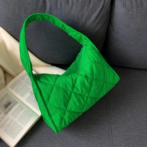 Detail shot of bright green quilted nylon shoulder bag with diamond lattice stitching
