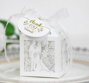 Detailed laser-cut white wedding favor box with Mr & Mrs text, ribbon and Thank You tag