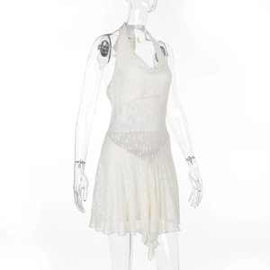 Detailed view of white backless halter mini dress with textured fabric and ruffled hemline