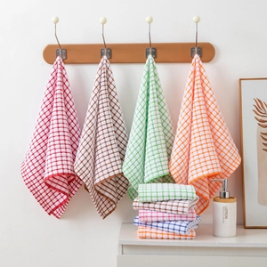 Absorbent multi-color checkered cotton tea towels hanging and folded for kitchen use