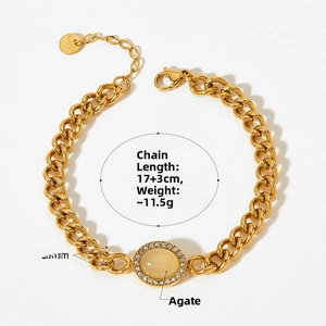 Detail of gold stainless steel Cuban chain bracelet with yellow agate and micro-inlays