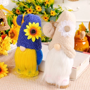Sunflower gnome plush decorations with yellow and white beards in a rustic setting