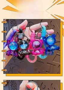 Close-up of four colorful astronaut bear keychains with woven straps and BOOM text