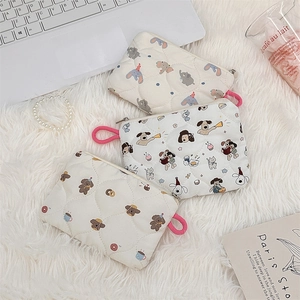 Detailed shot of quilted cotton pouches featuring elephant, bear, and cat prints