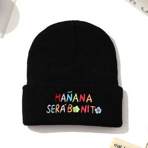 Black knit beanie featuring colorful Mañana Será Bonito floral embroidery for winter warmth