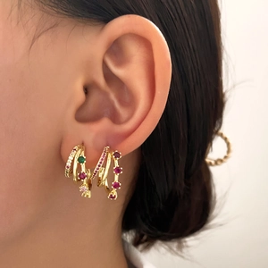 Layered gold C-shape earrings with colorful crystals and micro-pave diamonds on model