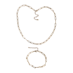 Flat lay of gold paperclip chain necklace and bracelet set with lobster clasp and extender