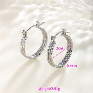 Macro view of silver chain-link textured hoop earrings showing 2cm diameter measurements