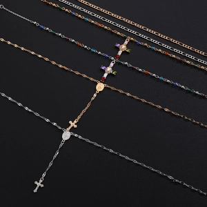 Detail of cross rosary necklaces with colorful beads on a black background