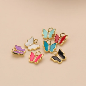 Golden butterfly pendants with colorful enamel inlay and sparkling rhinestone accents