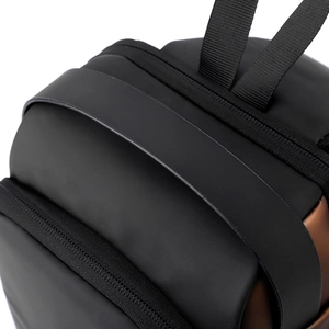 Detailed macro view of waterproof black and brown sling bag with premium matte finish