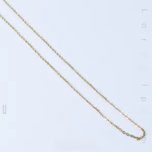 Macro detail of a 14k gold plated stainless steel O-chain necklace with polished finish