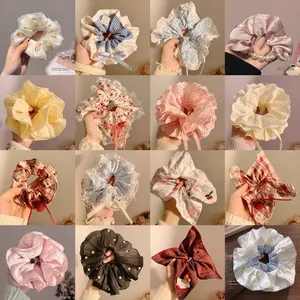 Collage of diverse fabric hair scrunchies with lace, pearls, and floral patterns