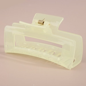Macro view of matte light green rectangular hair claw clip with golden metal spring