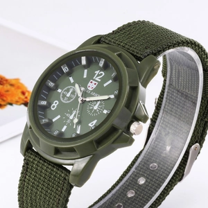 Close-up of military green men's watch with luminous hands and nylon woven strap