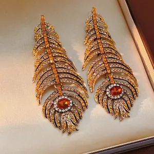 Vintage gold feather earrings with sparkling amber crystals and Bohemian rhinestone details