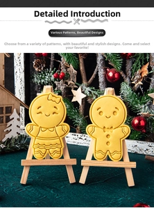 Detail view of gingerbread man and woman cookie cutters on mini wooden easels