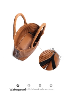 Detail of hand-woven brown leather tote bag showing velcro closure and inner storage