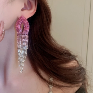 Detail view of long tassel earrings with pink gradient crystal fringe on a model