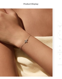 Close-up of S925 silver cross bracelet with pavé moissanite on a woman's wrist