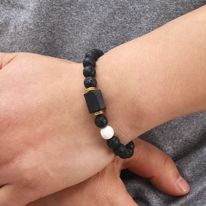 Men's Tiger Eye and Lava Stone magnetic beaded bracelet with gold spacers on a wrist