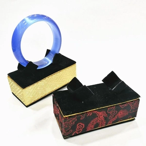 Detail of translucent sea blue bracelet on acrylic stands with traditional patterns