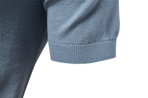 Close-up of high-density knit polo shirt cuff showing ribbed texture in Morandi blue