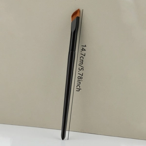 Detail view of concealer brush showing 14.7cm length and angled synthetic bristles