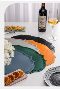 Stacked irregular leather placemats in multiple colors for elegant dining table setting