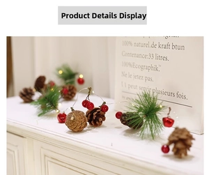 Detail of pine cones, red berries and bells on LED Christmas fairy light string