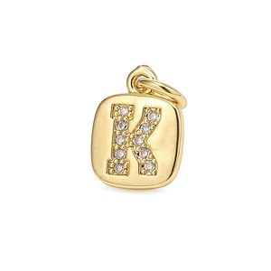 Detailed view of a gold rectangular pendant with zircon stones forming the letter K
