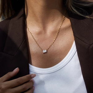 Detail of 18K gold stainless steel necklace featuring a teardrop white zircon pendant
