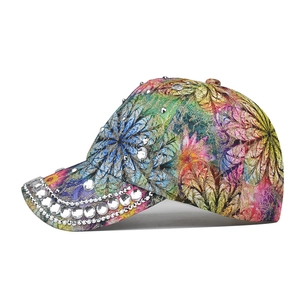 Close-up of colorful floral baseball cap with shiny rhinestones and metal stud details