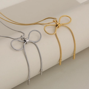 Elegant bow pendant necklace with sleek snake chain in gold and silver finish for women