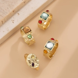 Set of 4 vintage gold-finished rings with colorful square and round gemstones