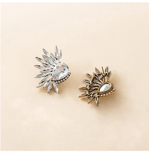 Detail of vintage crystal wing studs showing shimmering stones and metal ear pin structure