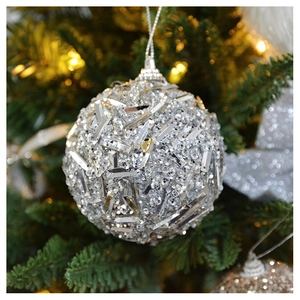 Macro view of silver champagne sequined Christmas ball ornament with hanging loop